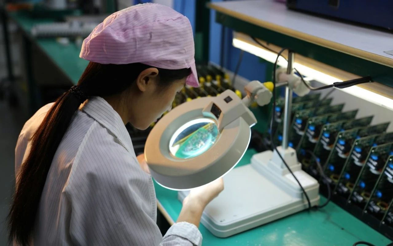 Operator inspecting PCBA during low-volume production review