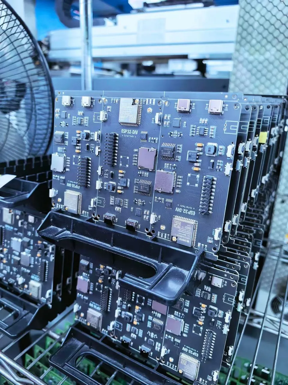 Printed circuit boards staged in a rack for a controlled production process