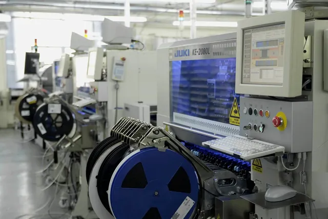 Representative SMT placement line with component reels and setup stations