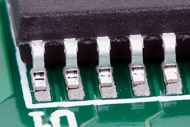 Close view of gull-wing component leads and solder fillets
