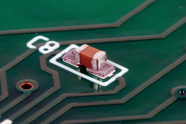 Small passive component soldered to PCB pads