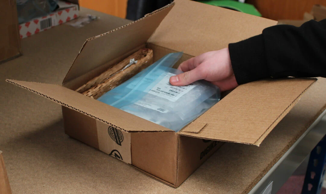 ESD-packed PCBA being placed into a shipment carton