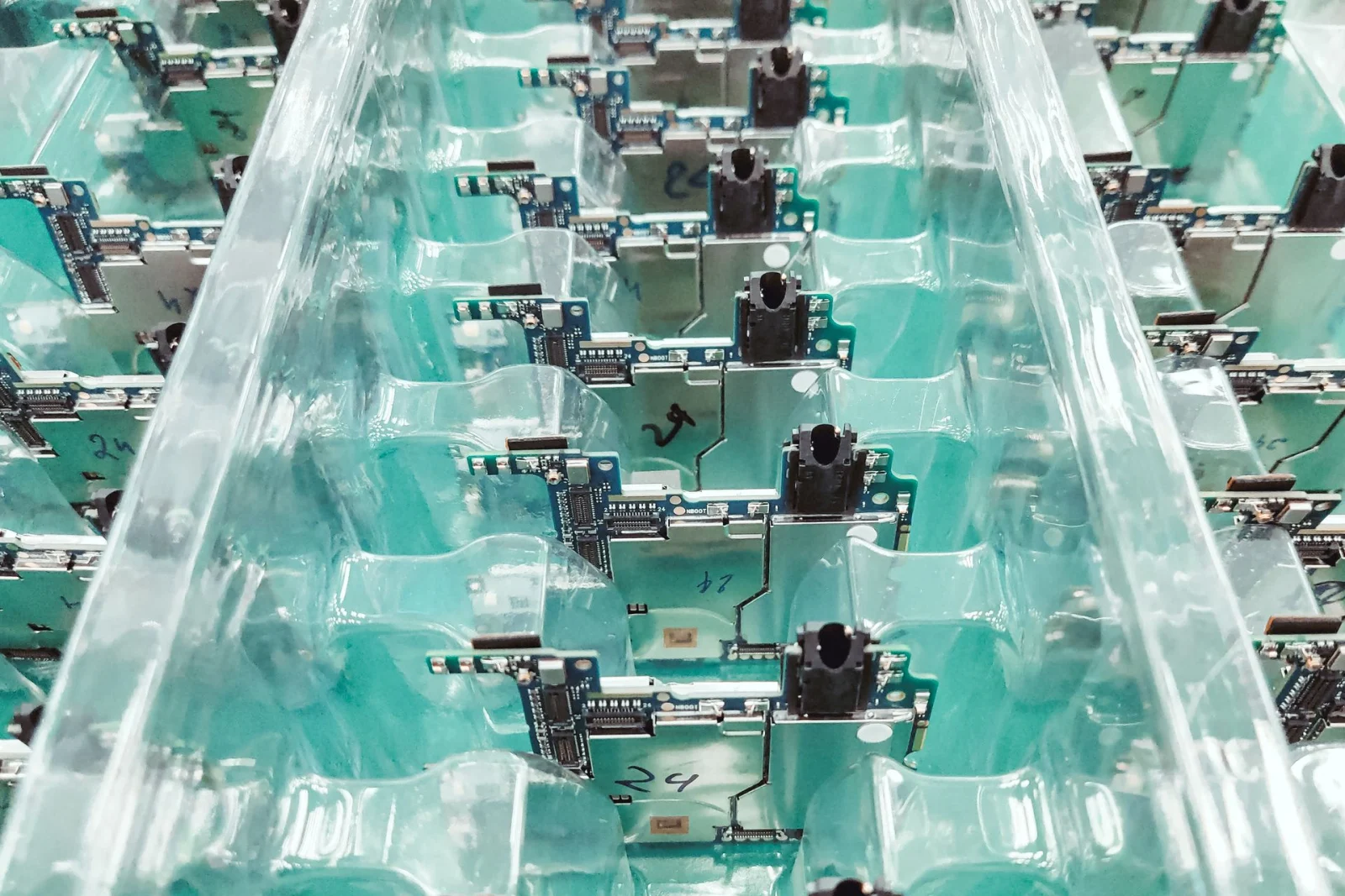 Assembled circuit boards arranged in trays.